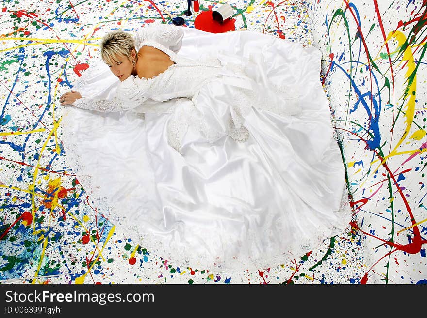 Beautiful young woman in bridal gown; splattered paint background; full body. Beautiful young woman in bridal gown; splattered paint background; full body