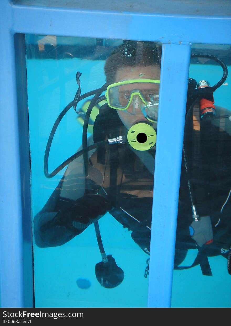 Diver in metal box in the water