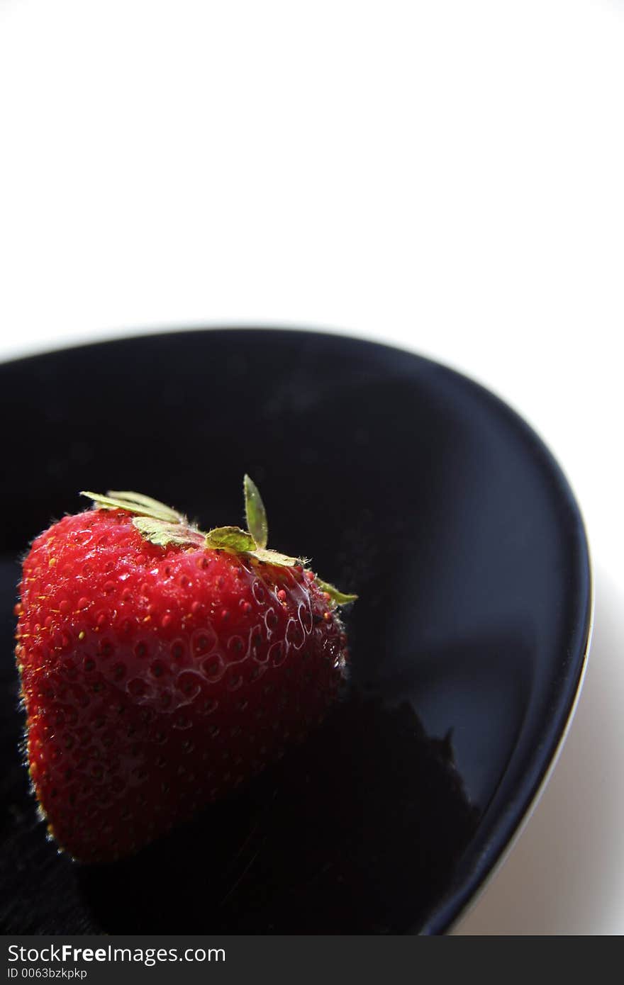 Picture of a strawberry on black plate