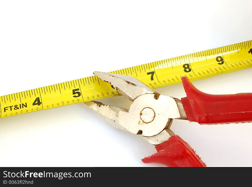 Pilers cut measure tape on white background. Pilers cut measure tape on white background