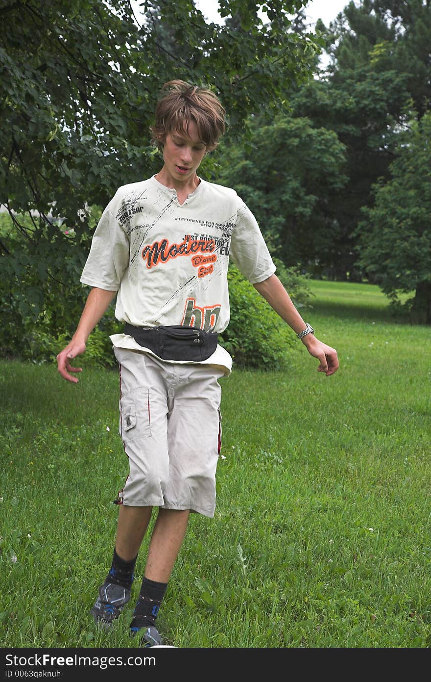 Boy play with boll on the green grass