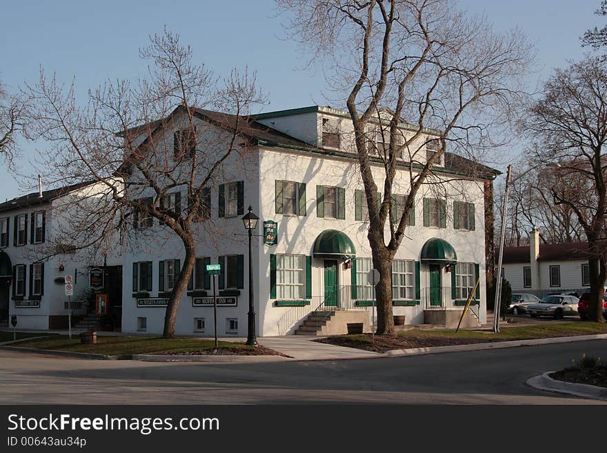 Moffat Inn, Niagara on the Lake, Canada. 3-storey white building with green door and windows.