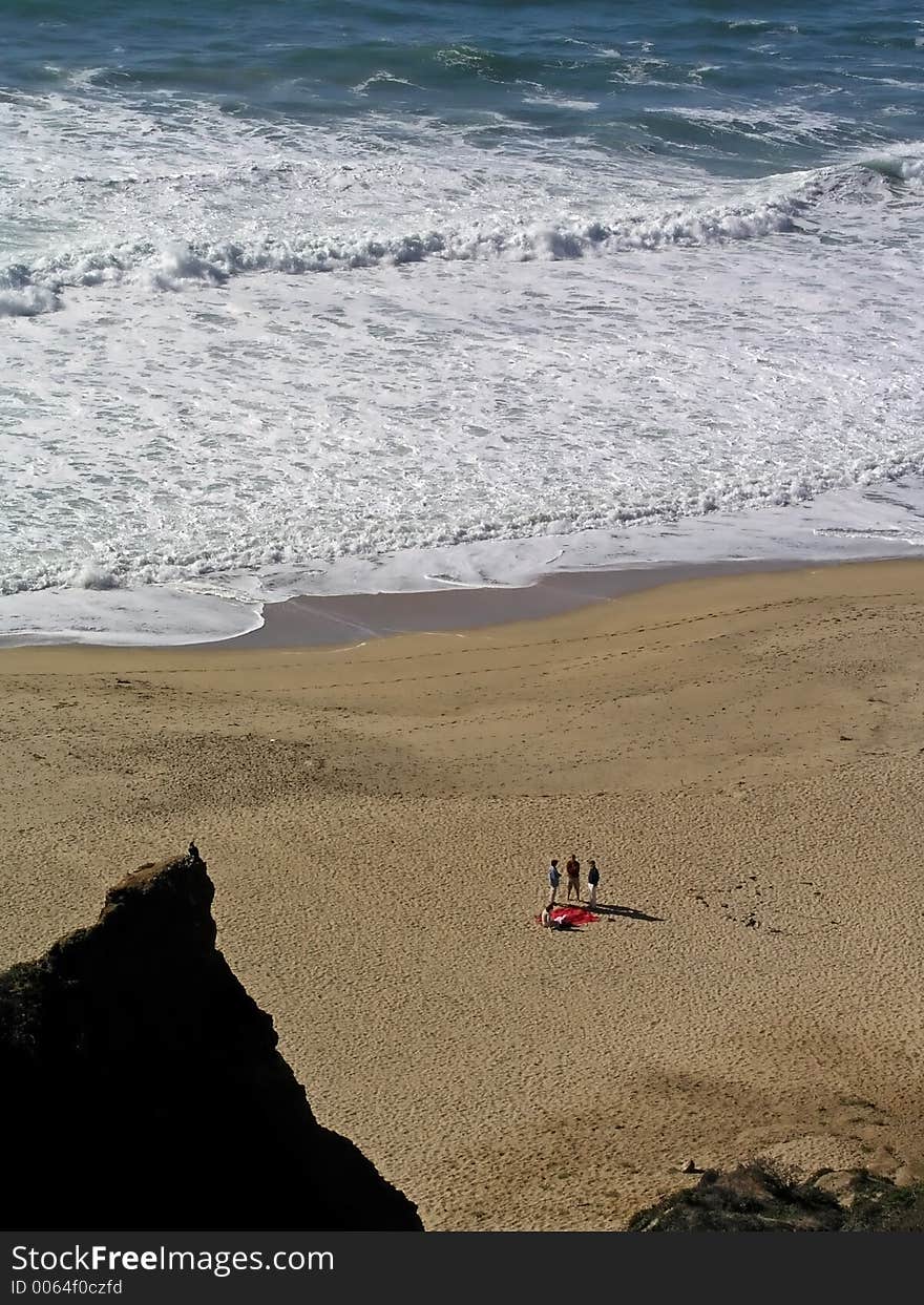 Three people on the beach