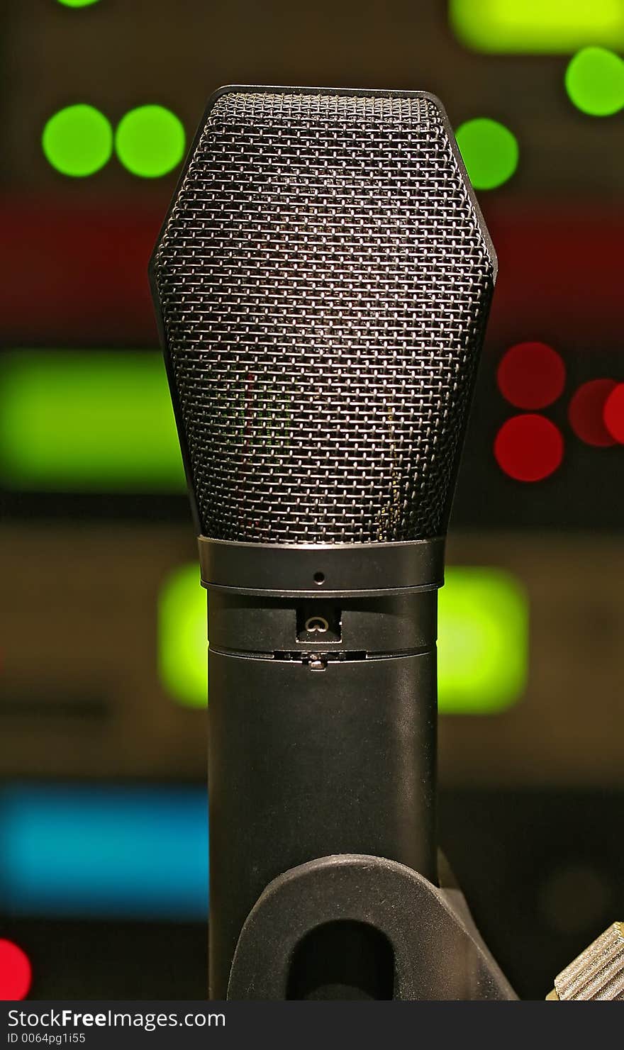 A condenser microphone with equipment LED's in the background