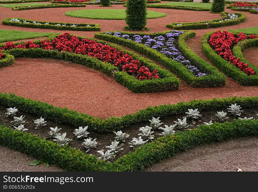 Flowerbeds with red, blue and white flowers