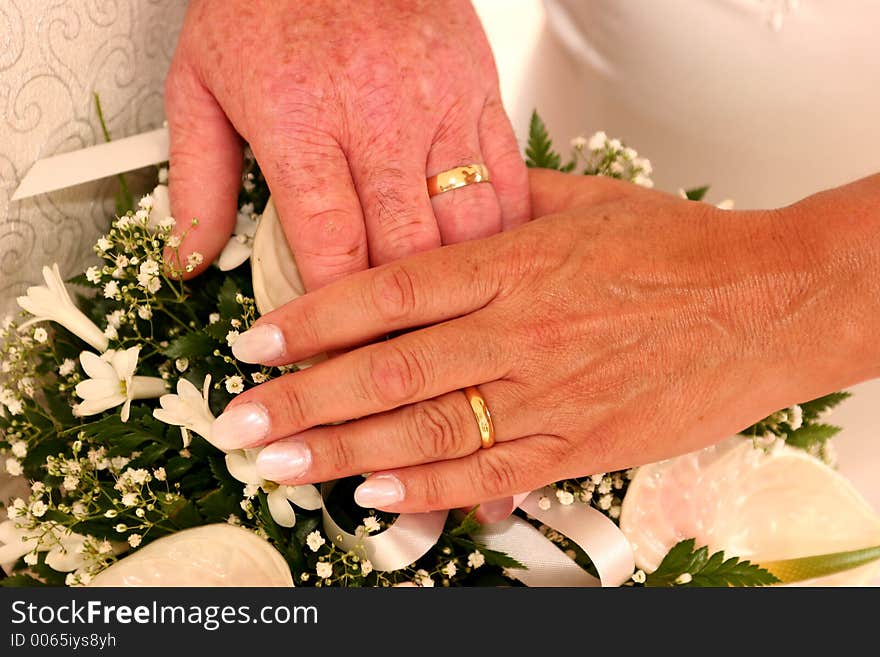 A newly married couple show off their rings. A newly married couple show off their rings