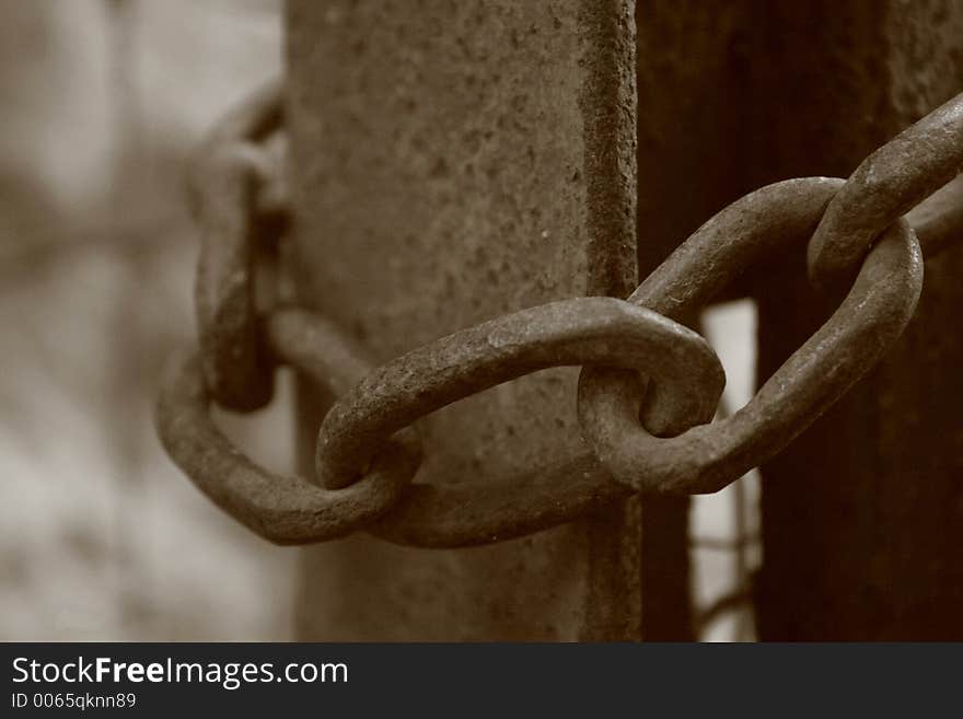 Old rusted chain holding iron gate closed. Old rusted chain holding iron gate closed.