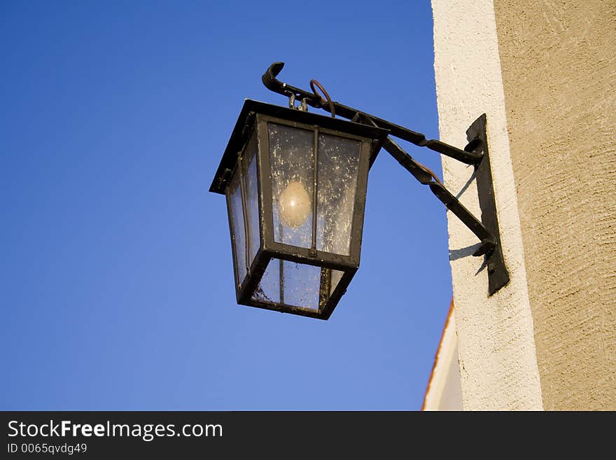 Old street lamp on blue sky