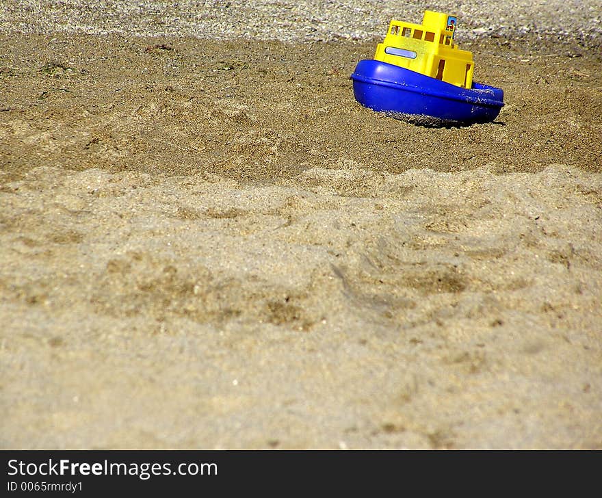 Toy boat failed on the beach. Toy boat failed on the beach