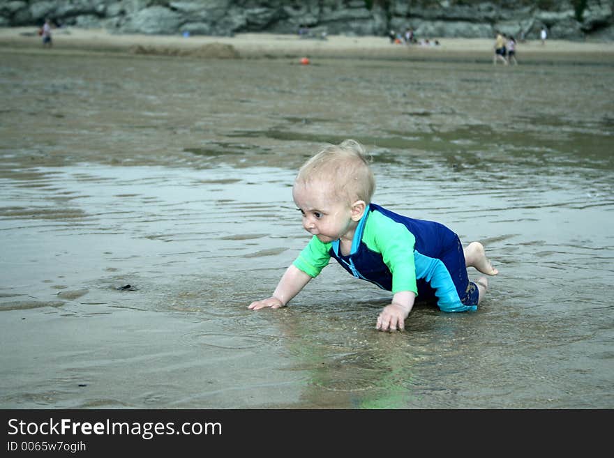 Small child exploring a beach in Cornwall. Small child exploring a beach in Cornwall.