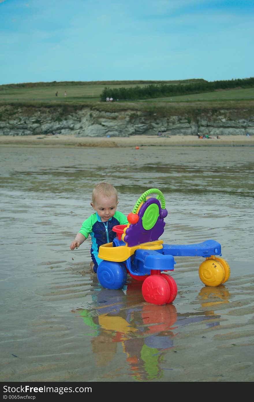 Small child exploring a beach in Cornwall. Small child exploring a beach in Cornwall.