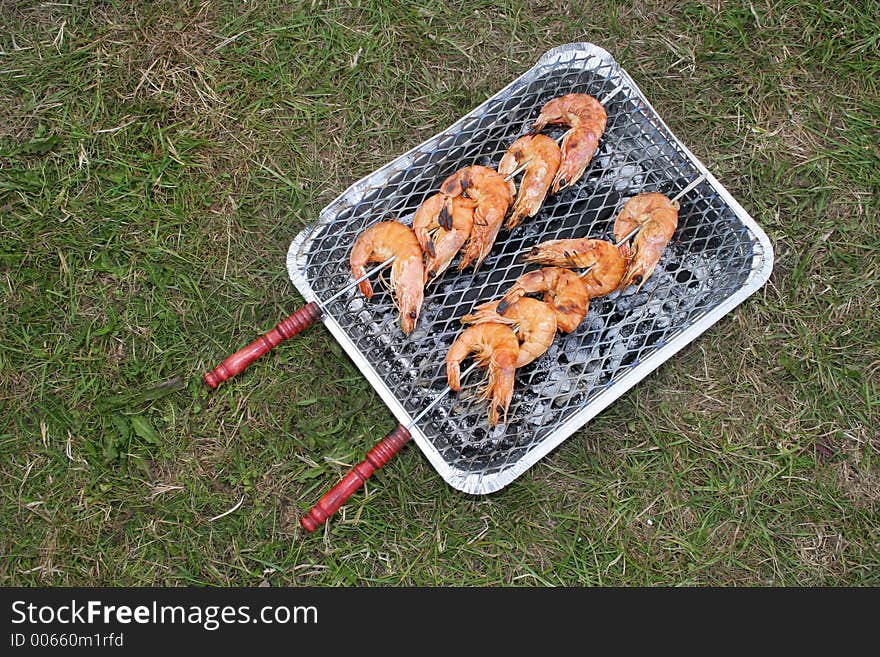 Disposable BBQ with room for text on grass background. Disposable BBQ with room for text on grass background