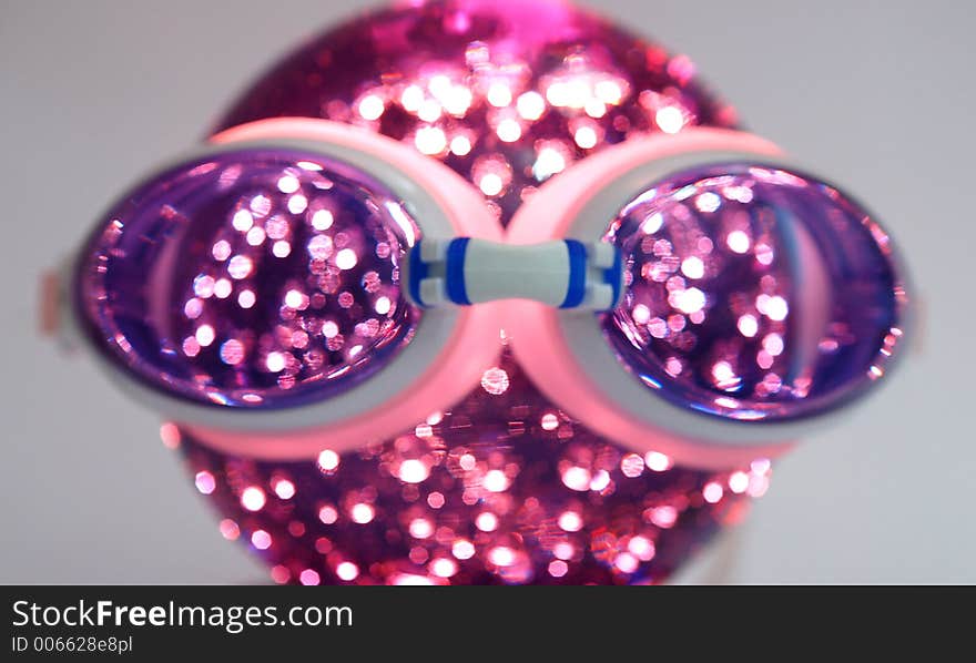 Goggle over a lighted globe. Goggle over a lighted globe