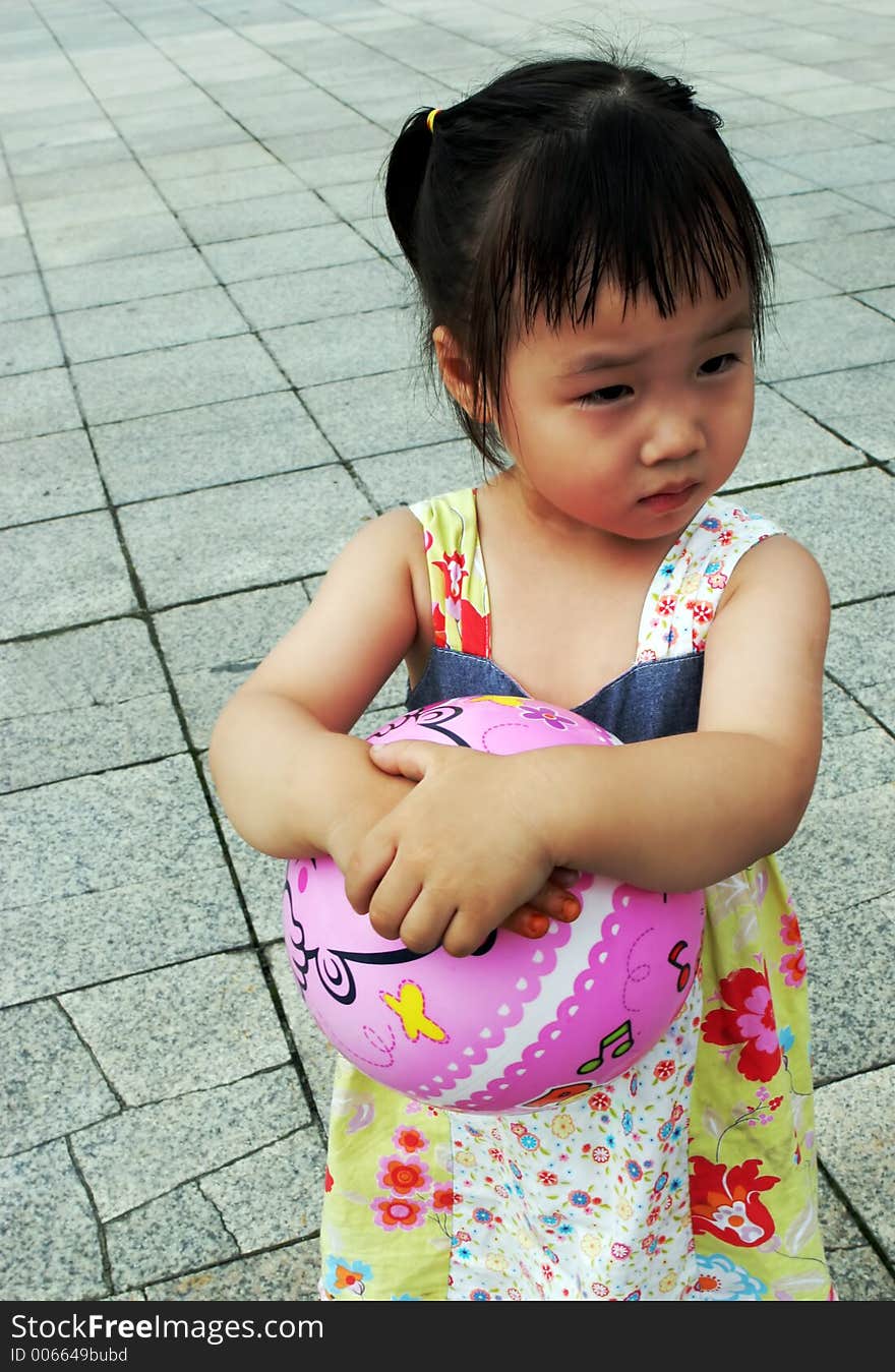 Cute Asian girl holding a ball