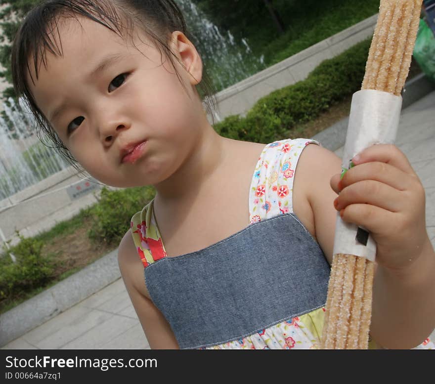 Young Korean girl eating a snack. Young Korean girl eating a snack