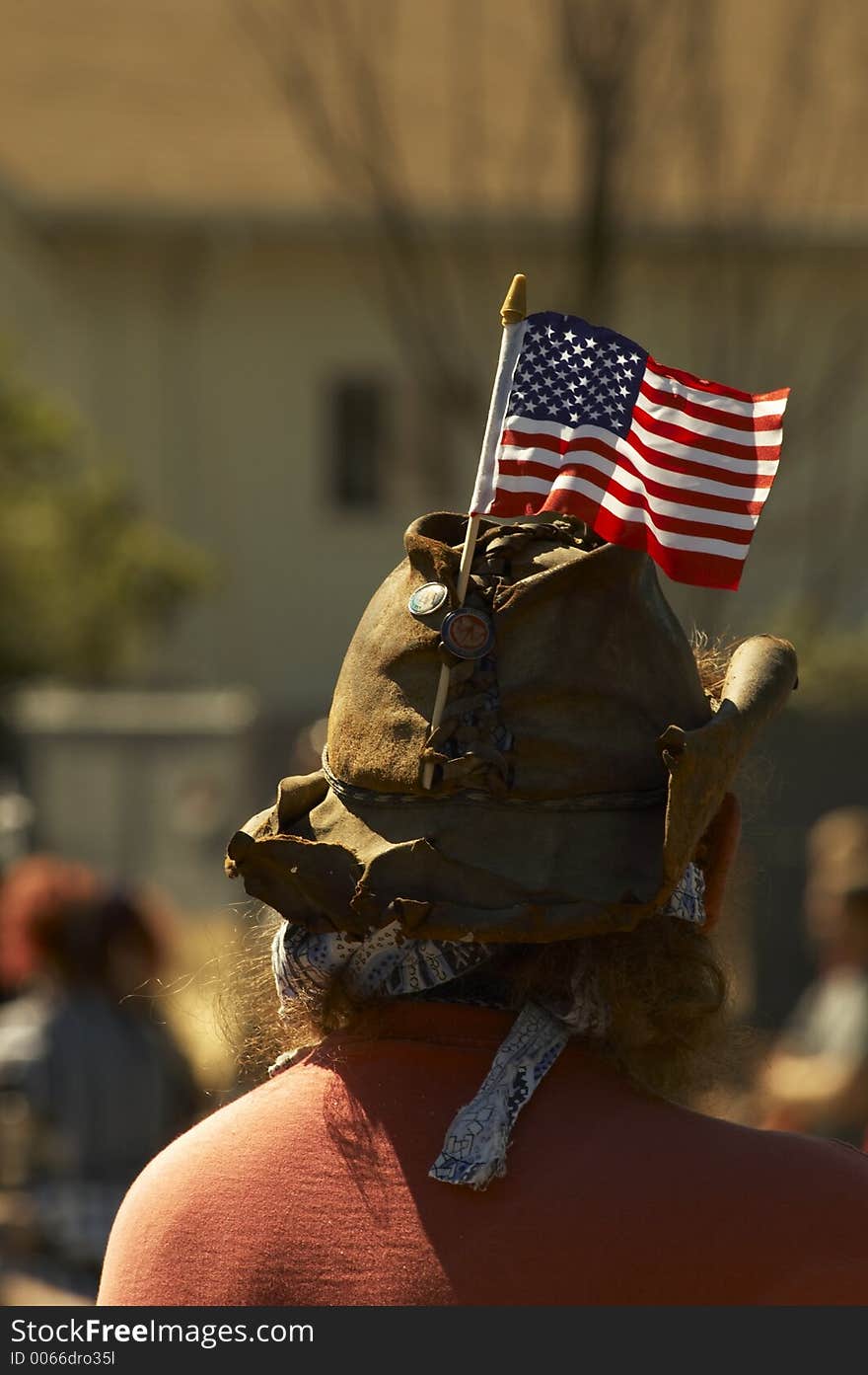 An american cowboy with an American flag attached to his leather hat. 4th of july.