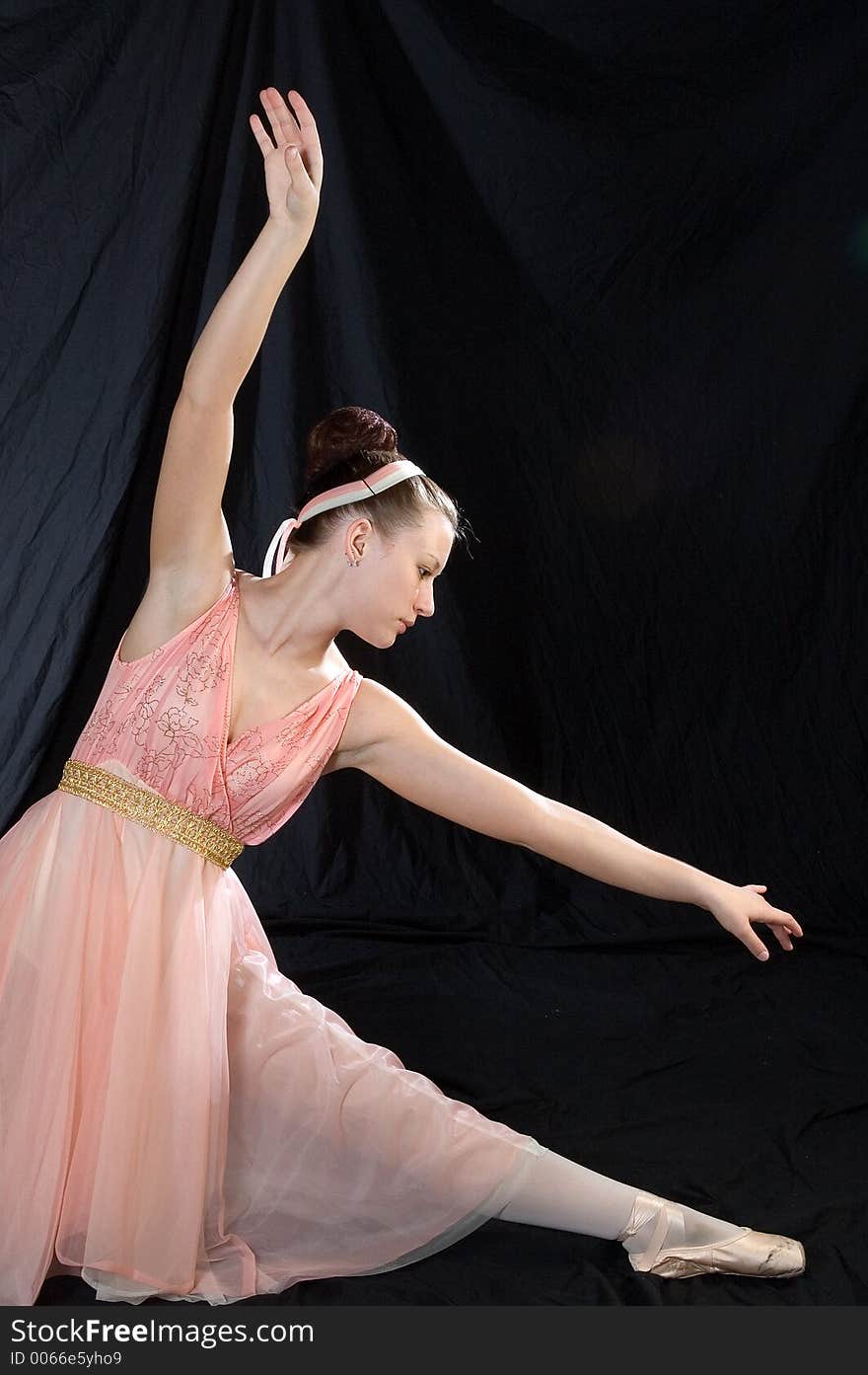 A ballet dancer poses in classic ballet pose. A ballet dancer poses in classic ballet pose