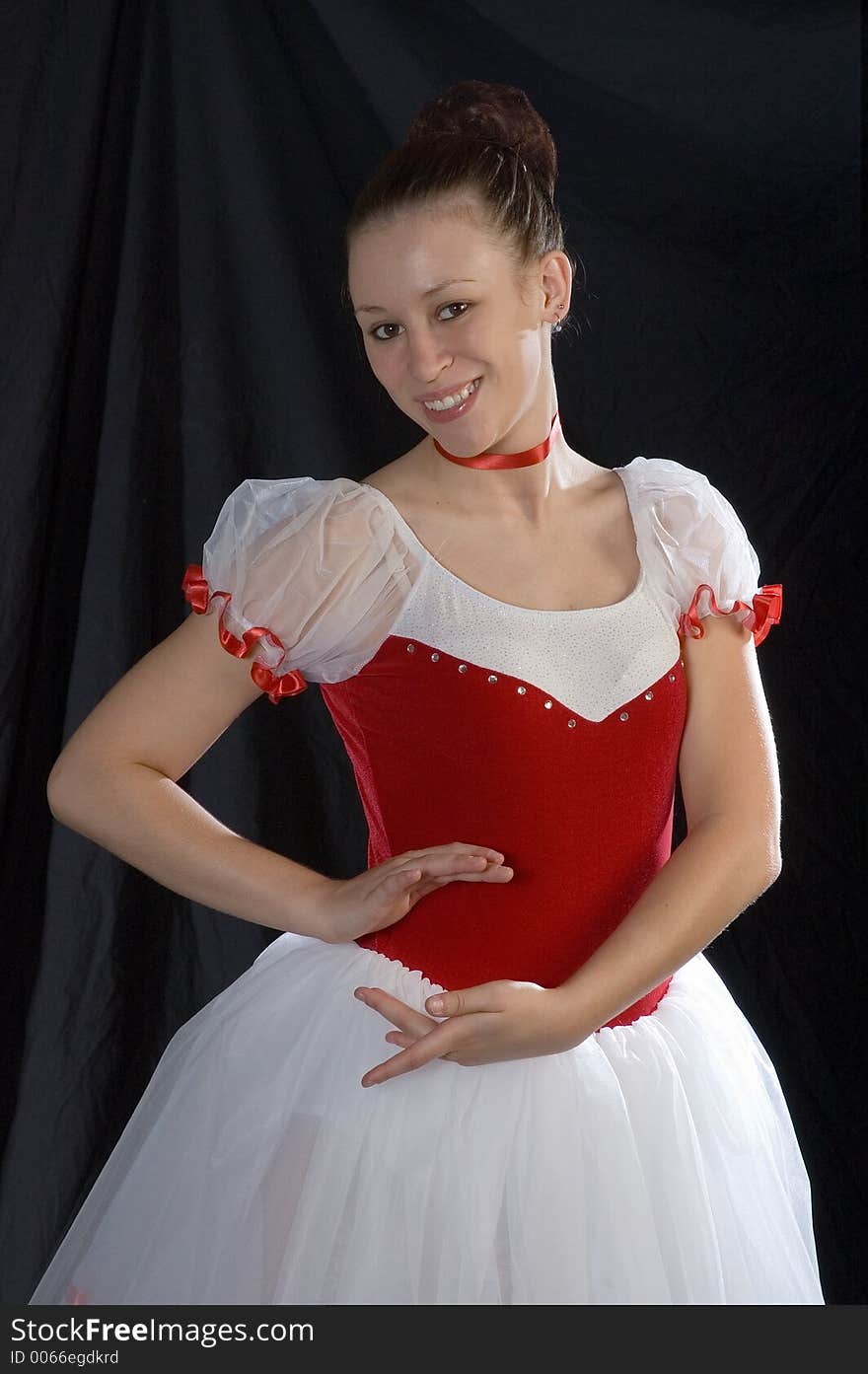 A ballerina photographed in a classic ballet pose.  Shot half length with ballerina smiling. A ballerina photographed in a classic ballet pose.  Shot half length with ballerina smiling