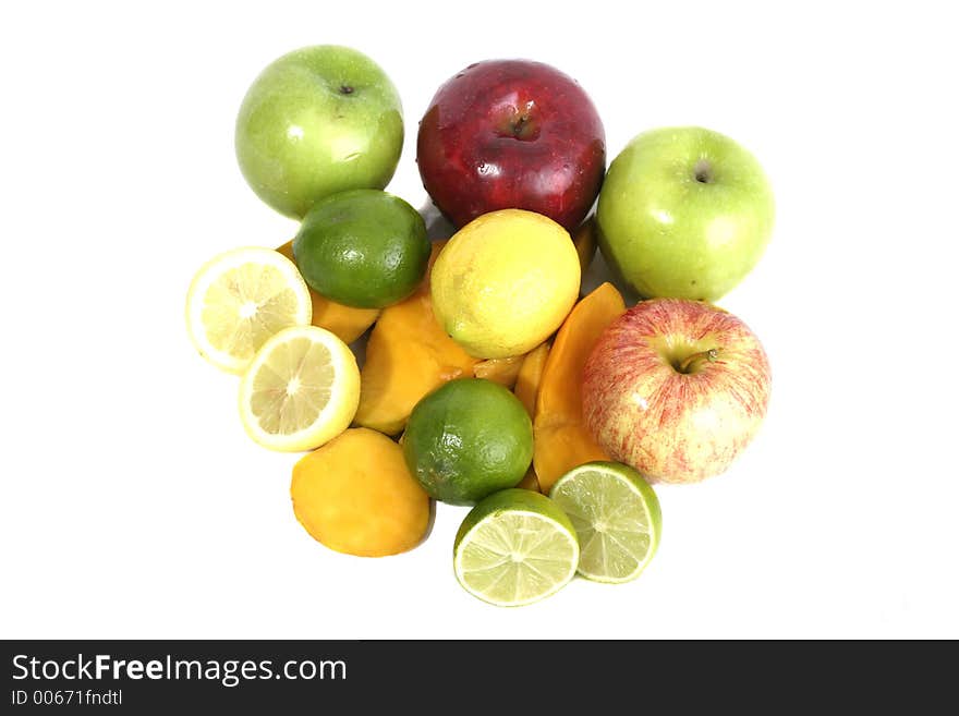 Large selection of colorful fruit including apples, lemons, limes, and cut mango on a white background. Large selection of colorful fruit including apples, lemons, limes, and cut mango on a white background.