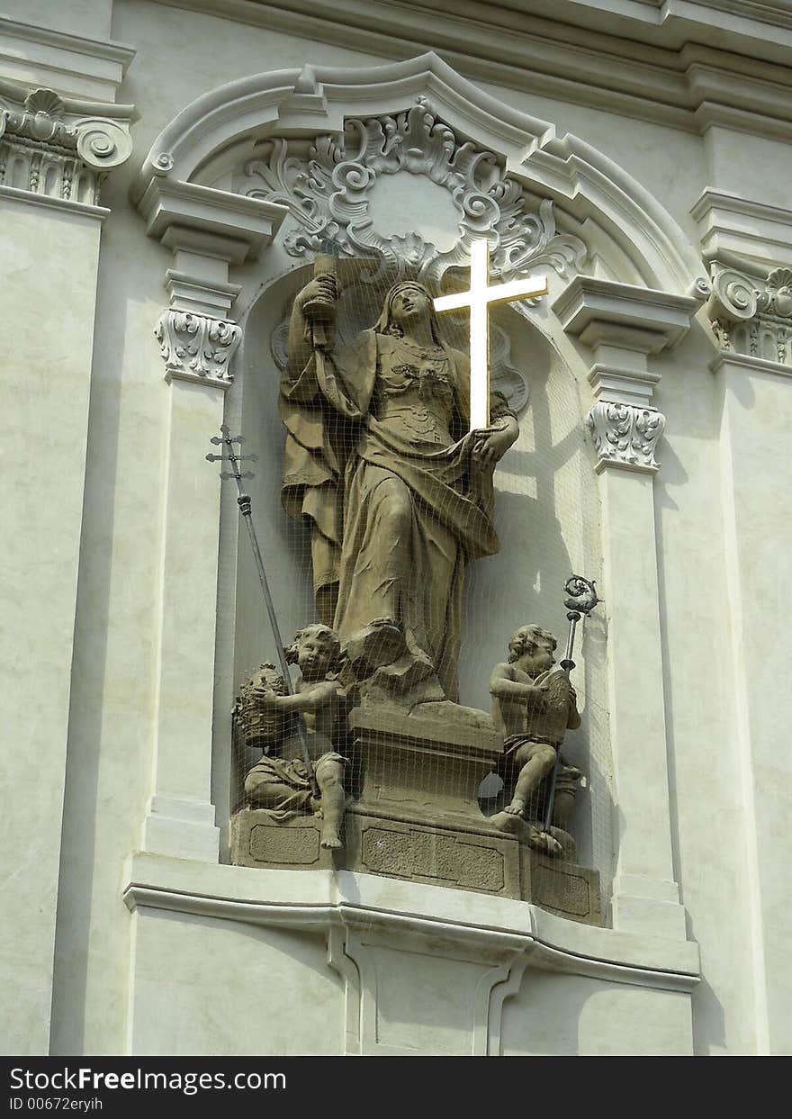 Statue on church in Prague behind net to escape from pigeons