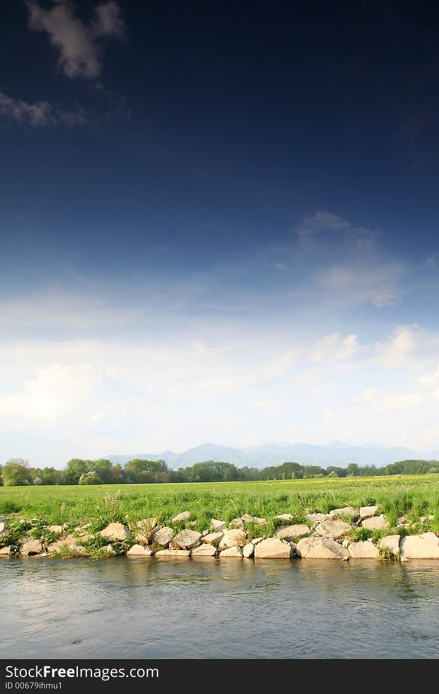 Rural country with stony waterside