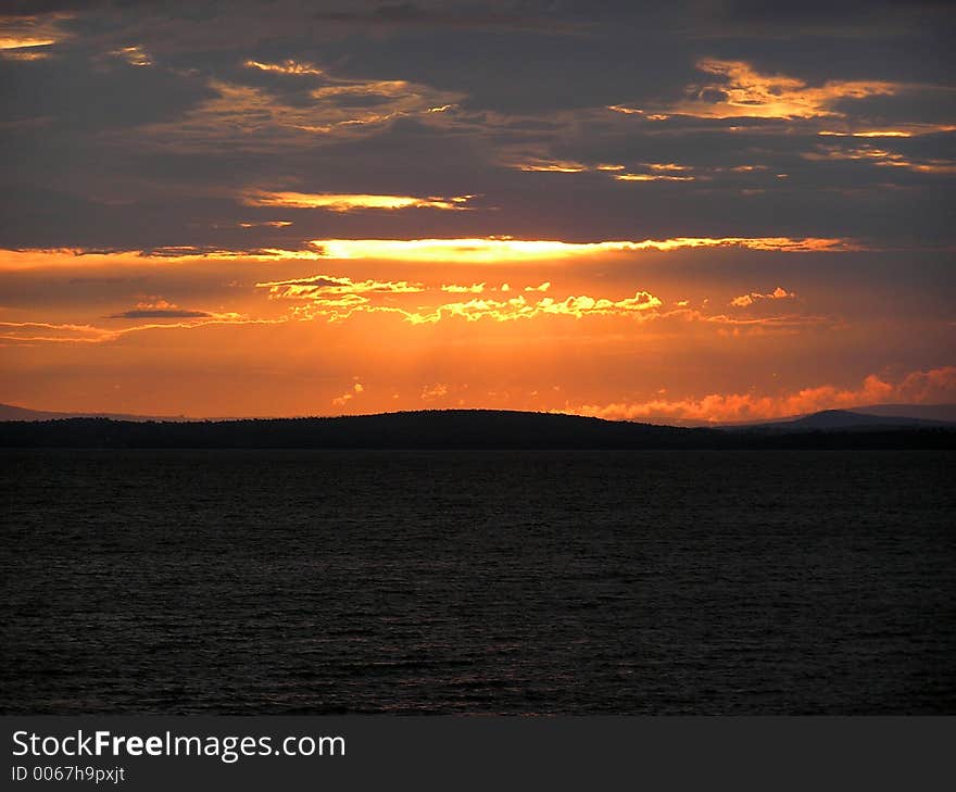 Sunrise over the Green Mountains of Vermont, Viewed from the New York side of Lake Champlain. Sunrise over the Green Mountains of Vermont, Viewed from the New York side of Lake Champlain