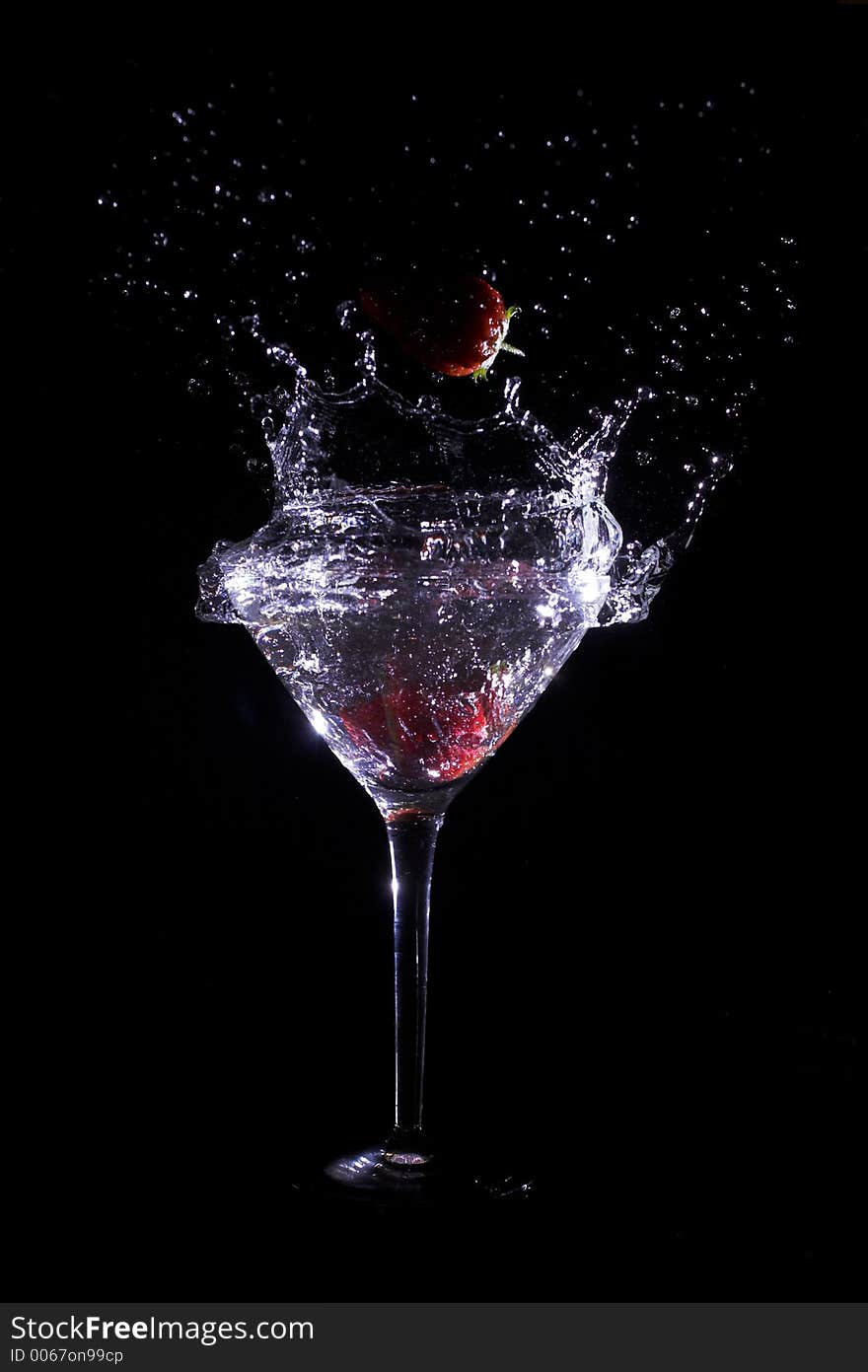 Strawberry falling into glass of water. Strawberry falling into glass of water