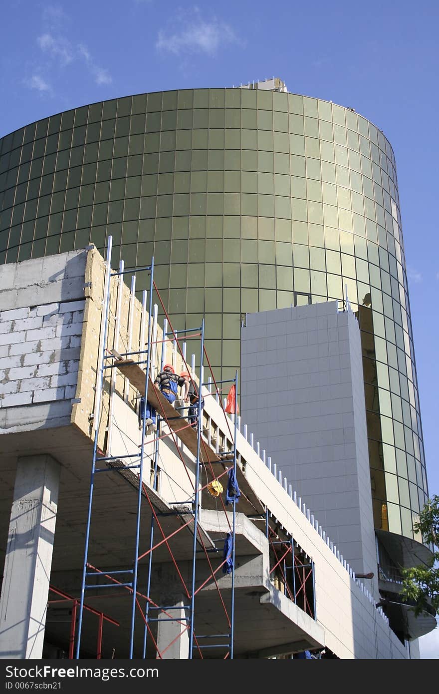 Construction of a building on a background of the blue sky