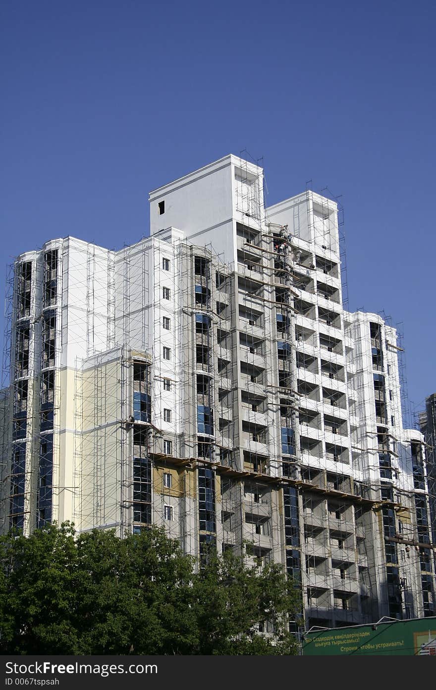 Construction of a building on a background of the blue sky