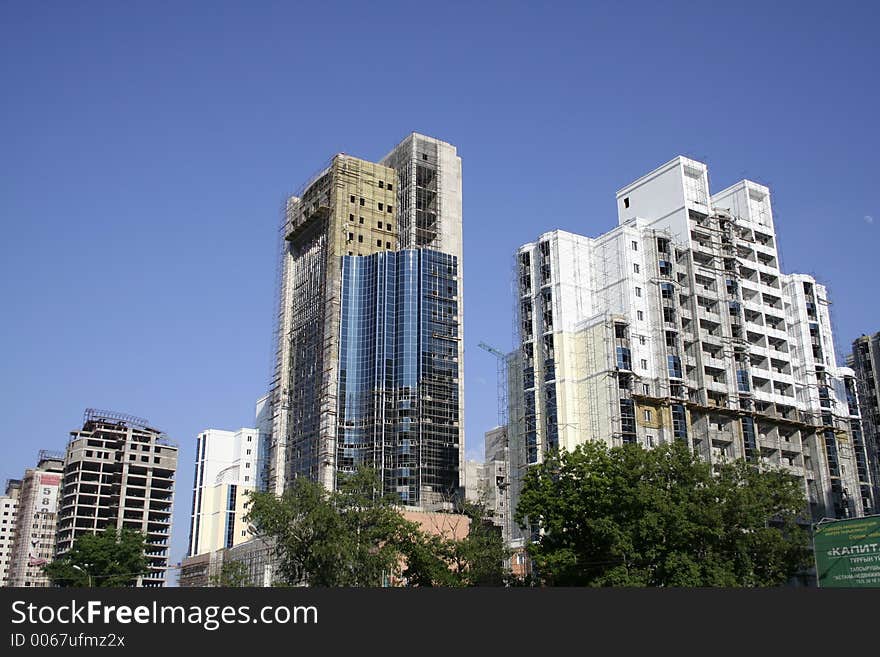 Construction of a building on a background of the blue sky