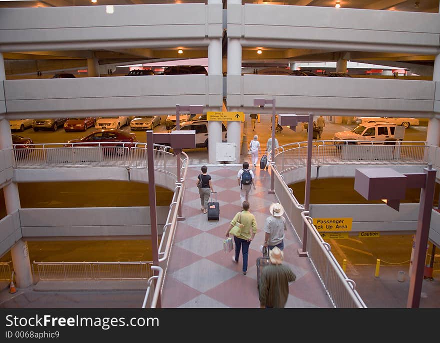 Passengers Rushing Through Airport Parking Structure