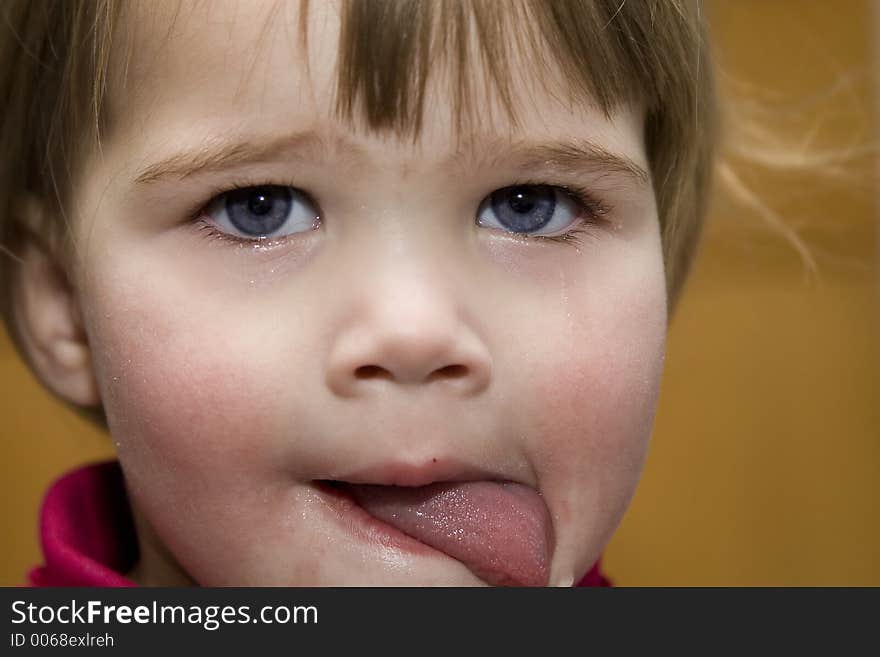 Girl licking tear from face. Girl licking tear from face