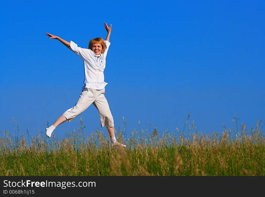 beauty girl jumping in field