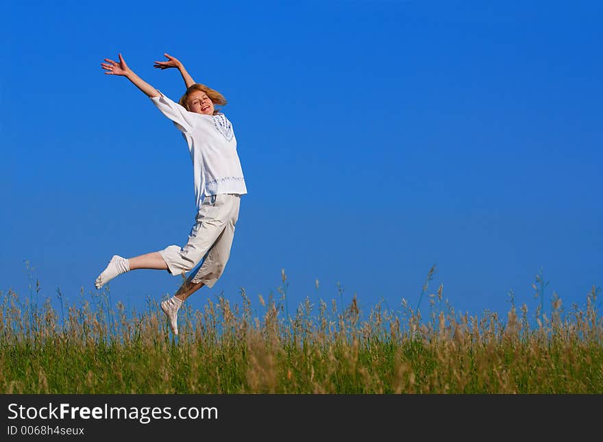 Beauty girl jumping in field