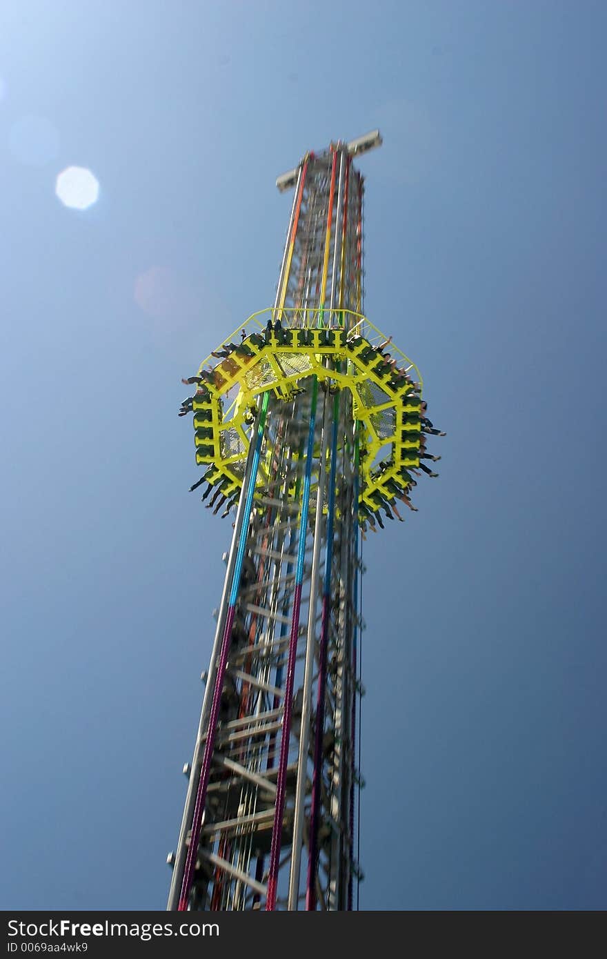 Passenger platform of a carnival free fall tower speeding down. Passenger platform of a carnival free fall tower speeding down