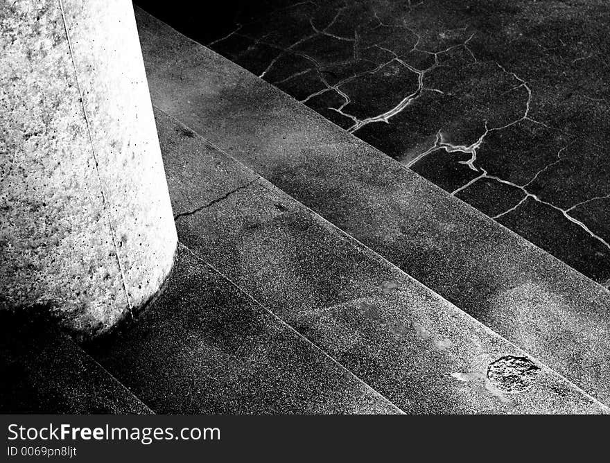 Close shot - white pillar at left, four steps. High contrast, moody. Close shot - white pillar at left, four steps. High contrast, moody.