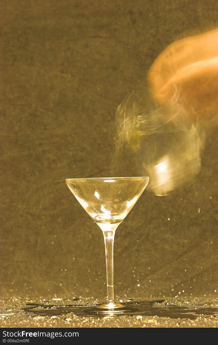 Blurred motion of throwing water into a martini glass. Blurred motion of throwing water into a martini glass