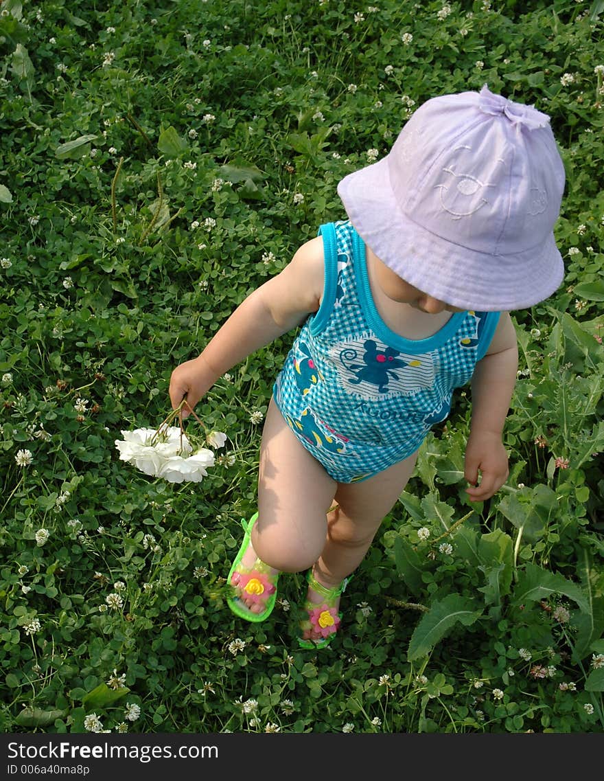 Little girl in lilac hat with white flower