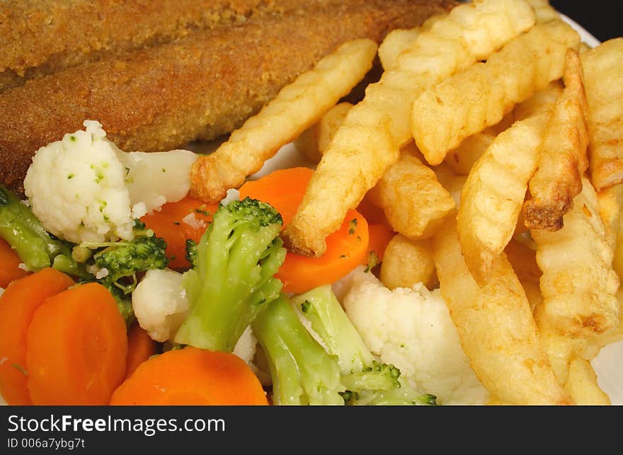 Crumbed sausages chips and vegetables. Crumbed sausages chips and vegetables