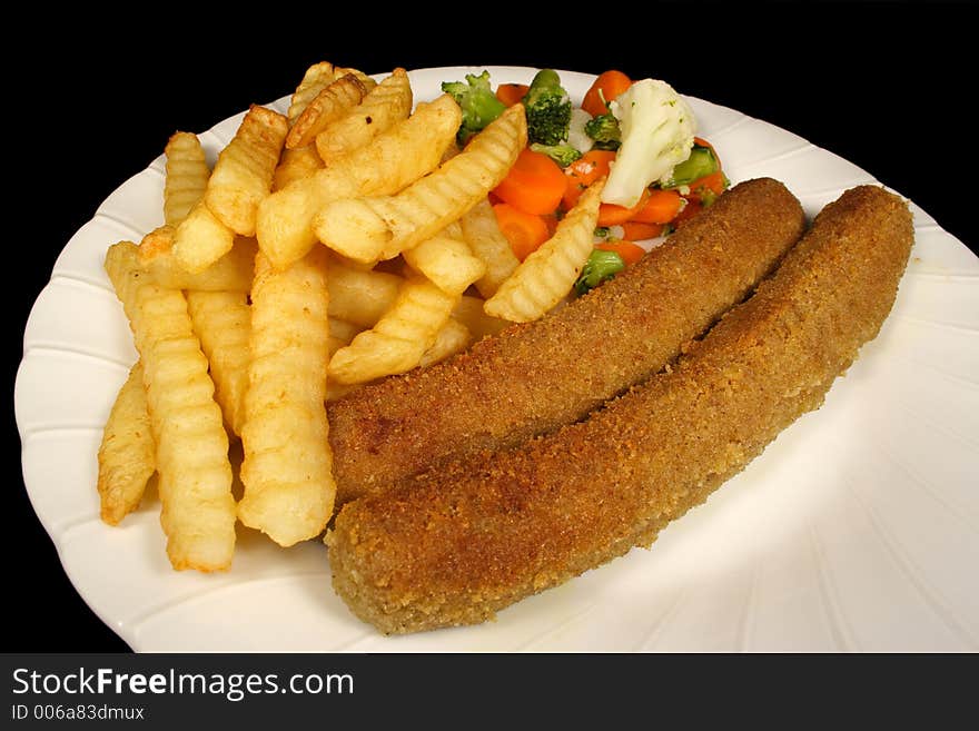 Crumbed sausages chips and vegetables. Crumbed sausages chips and vegetables