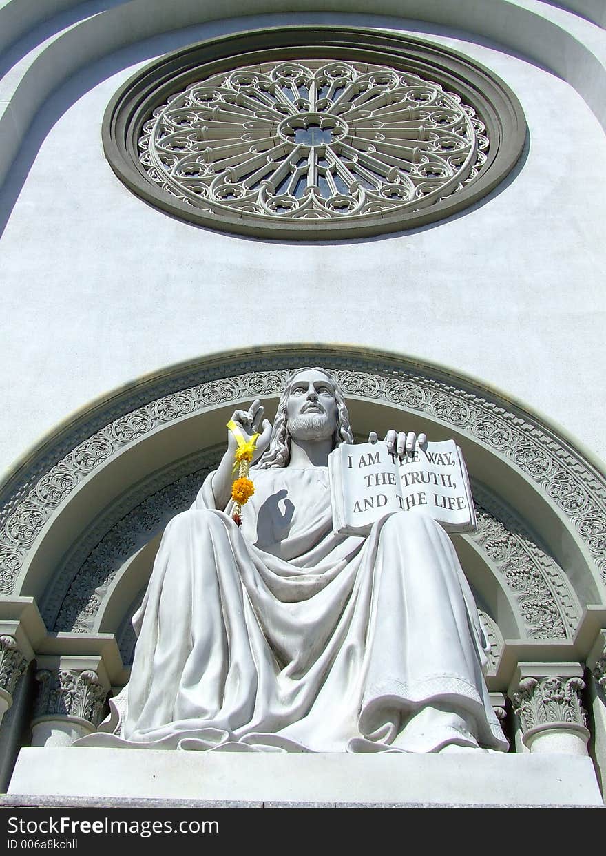 A scrupture of Jesu Magister located in front of a church