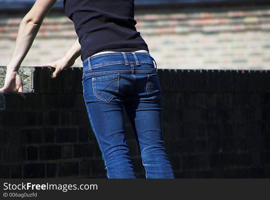 Young girl looking over the fence