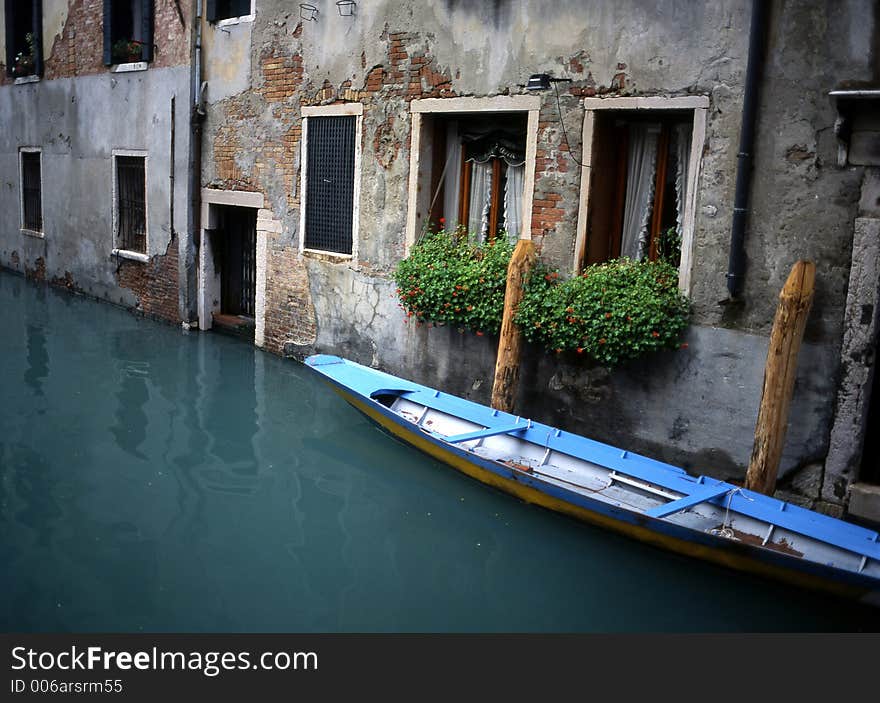 Gondola parked outside of someone's home in Venice, Italy.  Shot on medium-format slide film and scanned, for exquisite resolution at large print sizes. Gondola parked outside of someone's home in Venice, Italy.  Shot on medium-format slide film and scanned, for exquisite resolution at large print sizes.