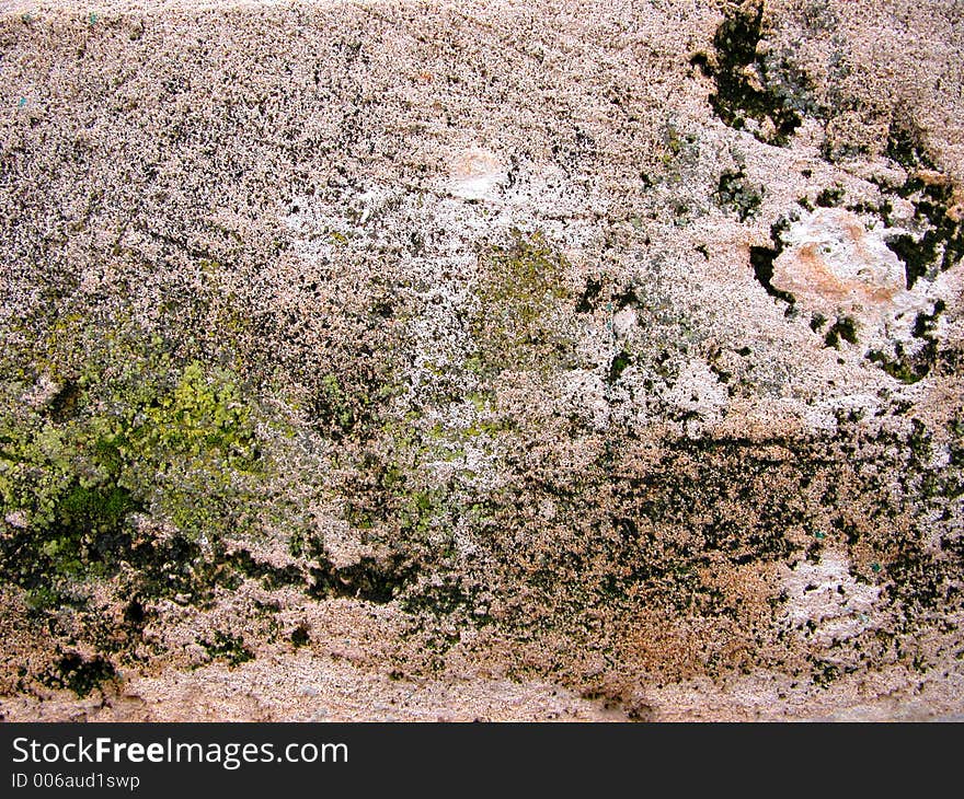 Eroded rock texture with some moss