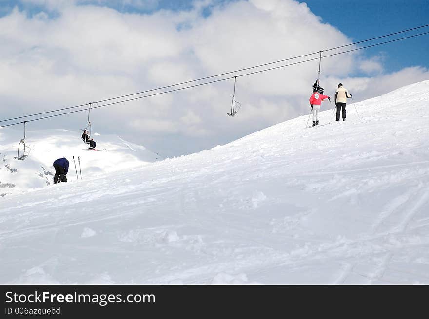 Two skiers looking track and waiting. Two skiers looking track and waiting