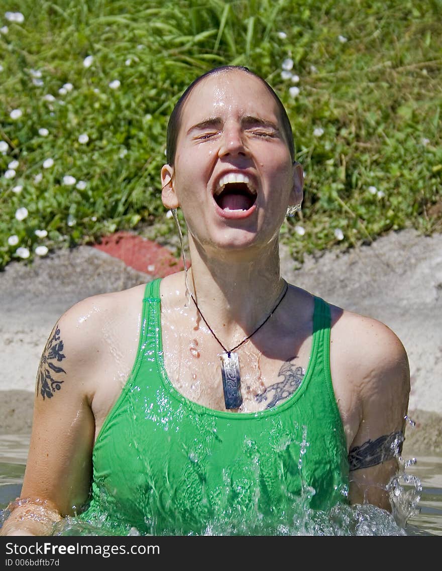 Woman exiting water in a splash. Woman exiting water in a splash