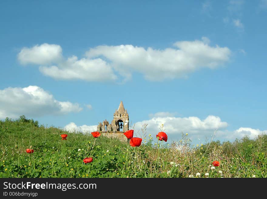 Old church tower in poppy field