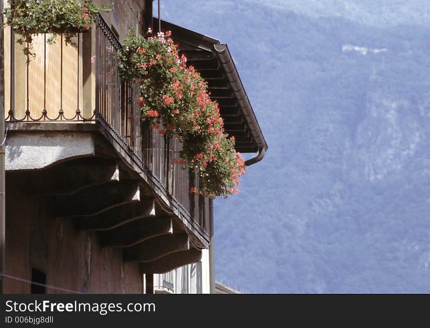 Geranium flowered balcony open on alpine view, Italian Lakes area. Geranium flowered balcony open on alpine view, Italian Lakes area.