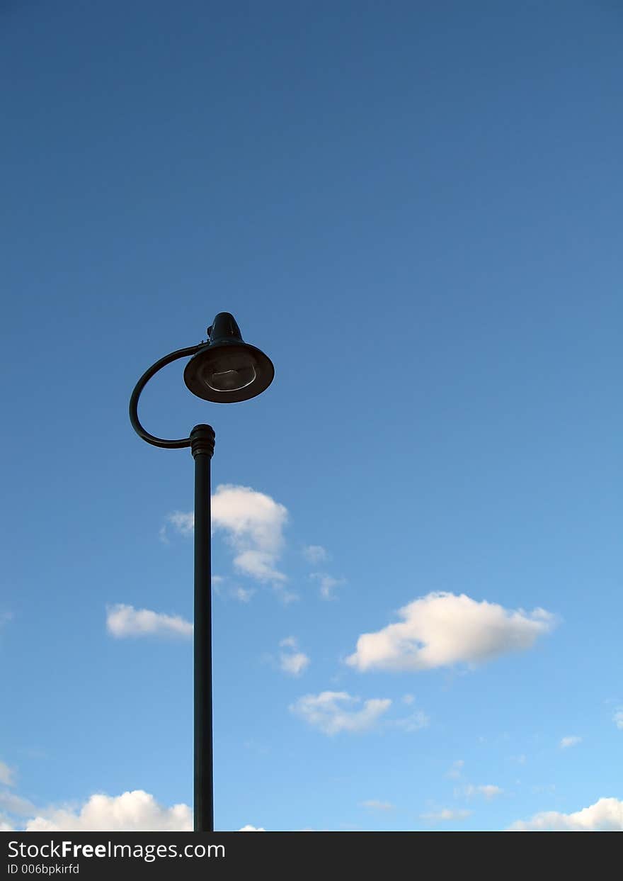 Single streetlight against blue sky.