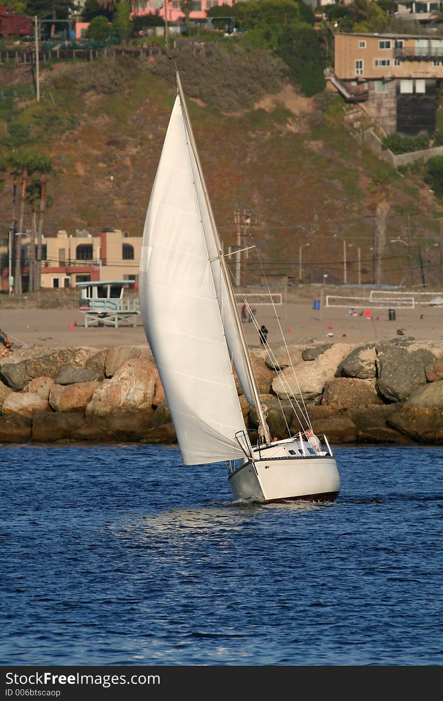 Reaching sailboat, along the coast